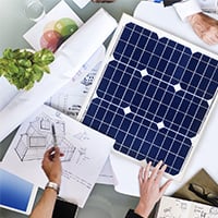 A group engages in the installation of a solar panel in Jaipur, Rajasthan, emphasizing renewable solar energy efforts.